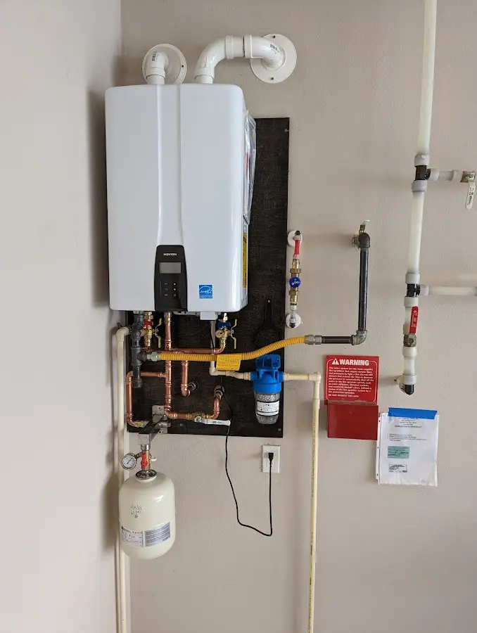 Professional plumber installing copper piping in a Harrisonville home